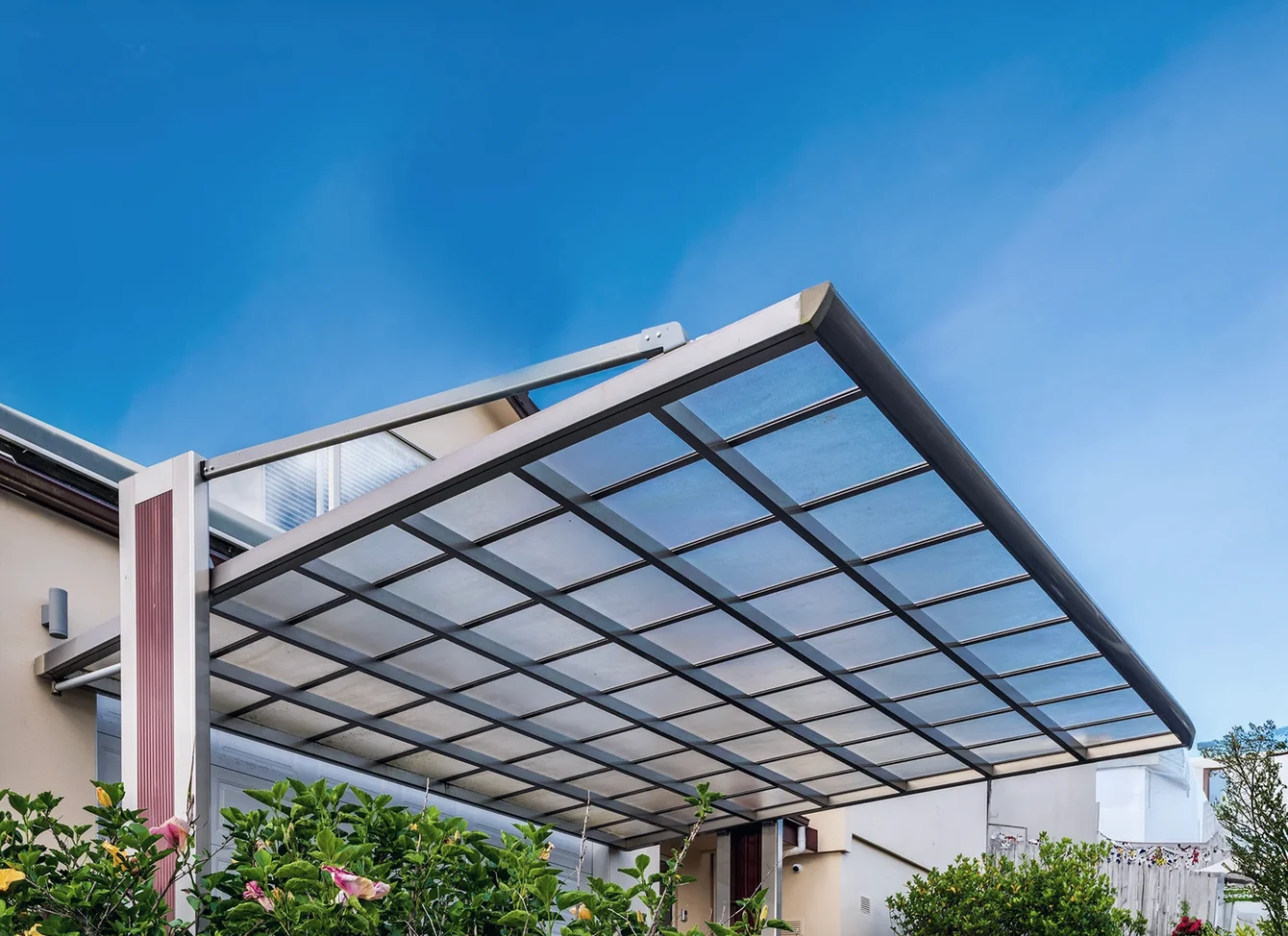 Heavy-duty outdoor drop awning blind providing wind and UV protection on a patio.