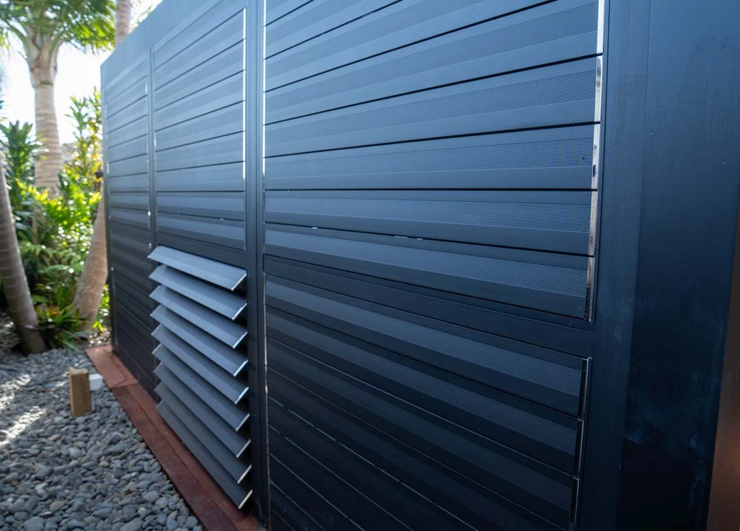 Minimalist architectural louvre structure integrated alongside a modern residential facade.