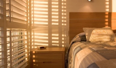 Water-resistant white PVC window shutters installed in a modern bathroom wet area.