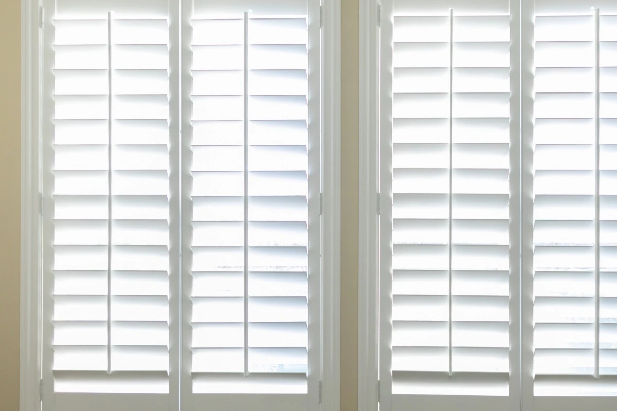 Premium natural timber window shutters custom painted to match interior living room decor.