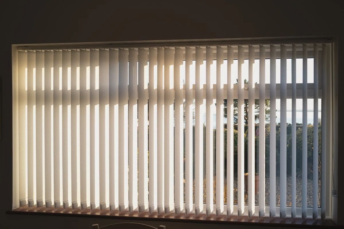 Sleek Vertical blinds installed over a large sliding glass door for modern light management.
